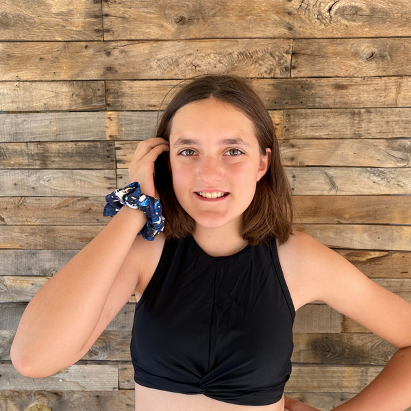 Close up picture of abstract navy blue scrunchie pictured on wrist of owner. Pipevine Designs.