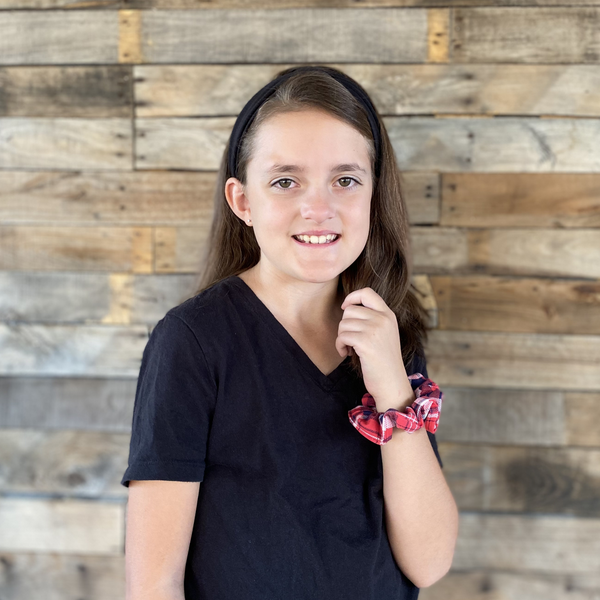 red and blue plaid matte scrunchie on wrist