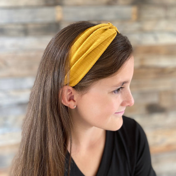 Mustard ribbed faux knot headband ear warmer on head side headband view Pipevine Designs