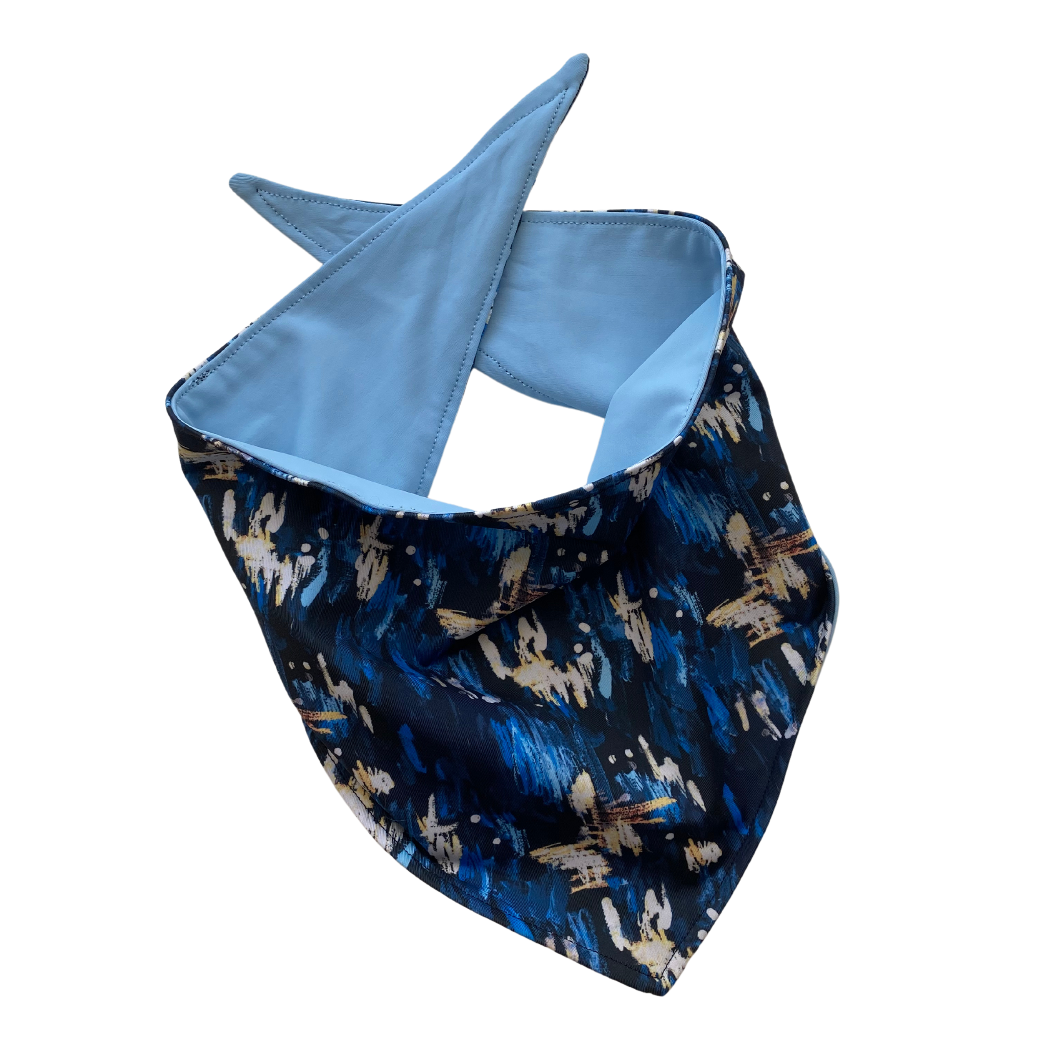 Close up picture of reversible dog swim scARF, aka cooling bandana for dogs. Showcasing a light blue color on one side and an abstract navy blue print on the other side. Pipevine Designs.