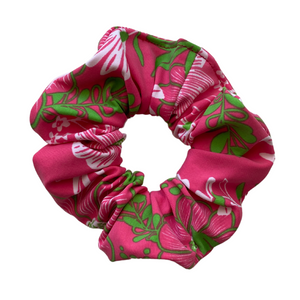 Close up picture of floral print with lime green on hot pink swim scrunchie. Pipevine Designs.